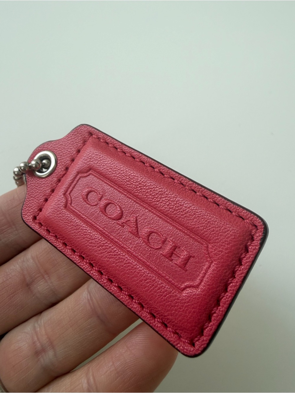 Coral rosy-pink vintage Coach leather bag tag in mint condition
